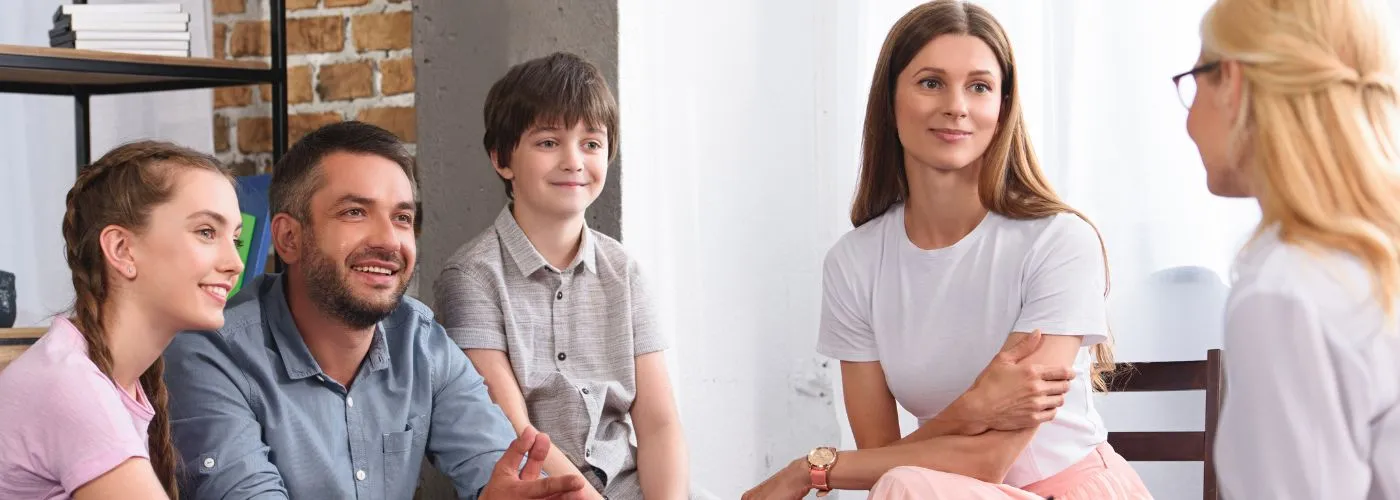 Family members improving communication through family therapy sessions