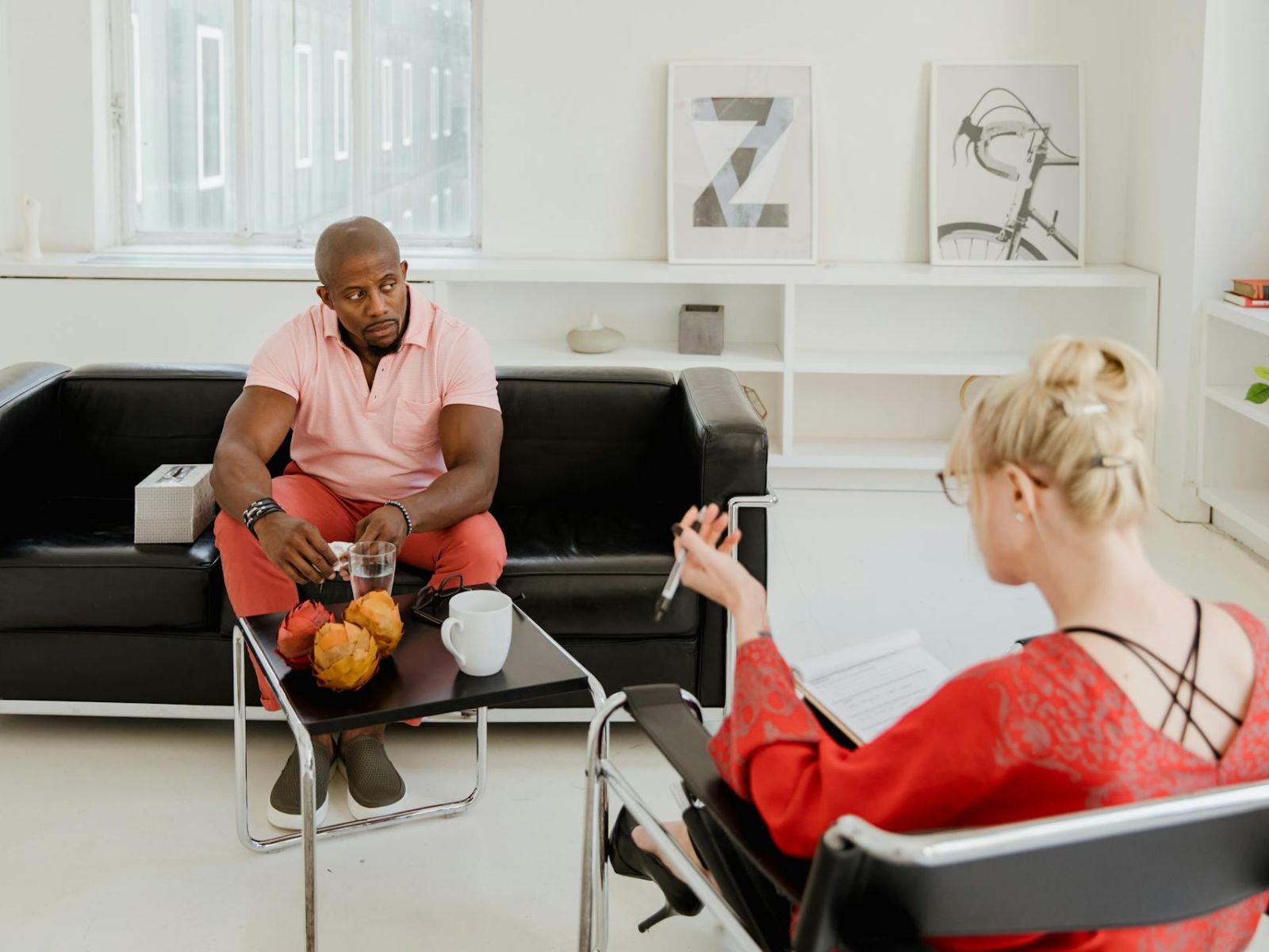 Therapist. Man and woman sitting in room in therapy session.