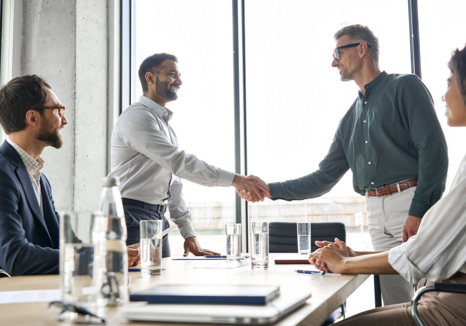 Navigating Workplace Challenges. Two Happy Diverse Professional Business Men Executive Leaders Shaking Hands After Solving workplace dispute.