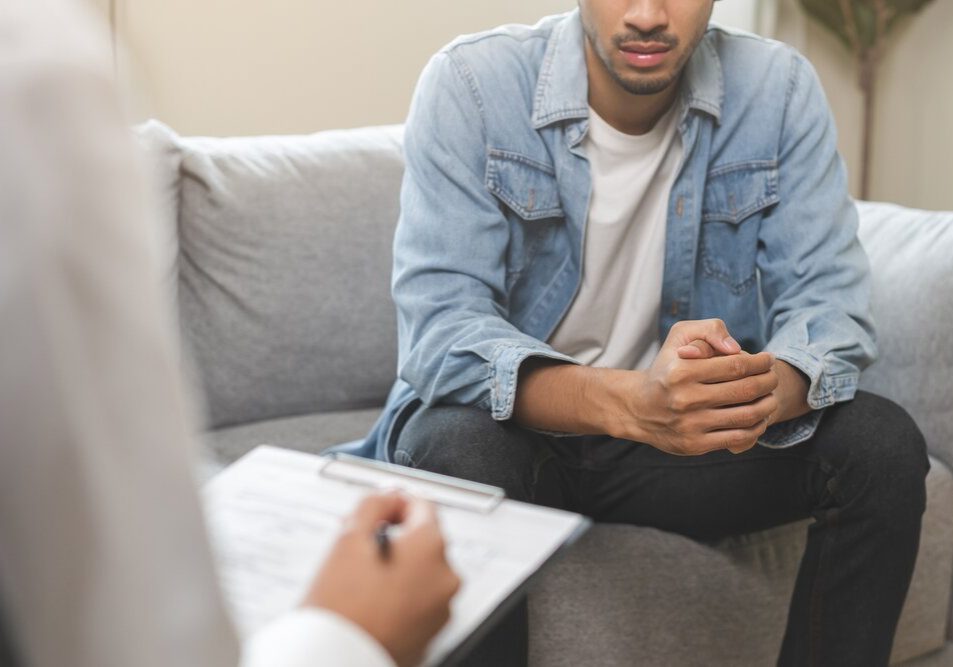 Anxiety therapy. Man suffering from Anxiety in a session with a therapist.