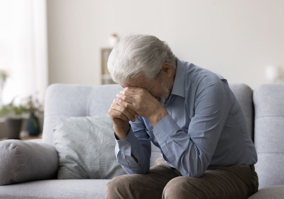 Depression. Depressed Older Retired Man Sit On Sofa crying Covering Face